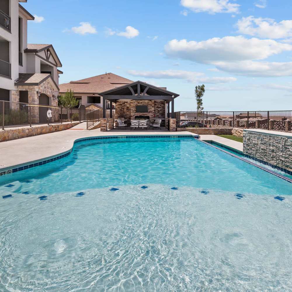 Sparkling swimming pool with view of grill station at Retreat at Horizon Hills in El Paso, Texas