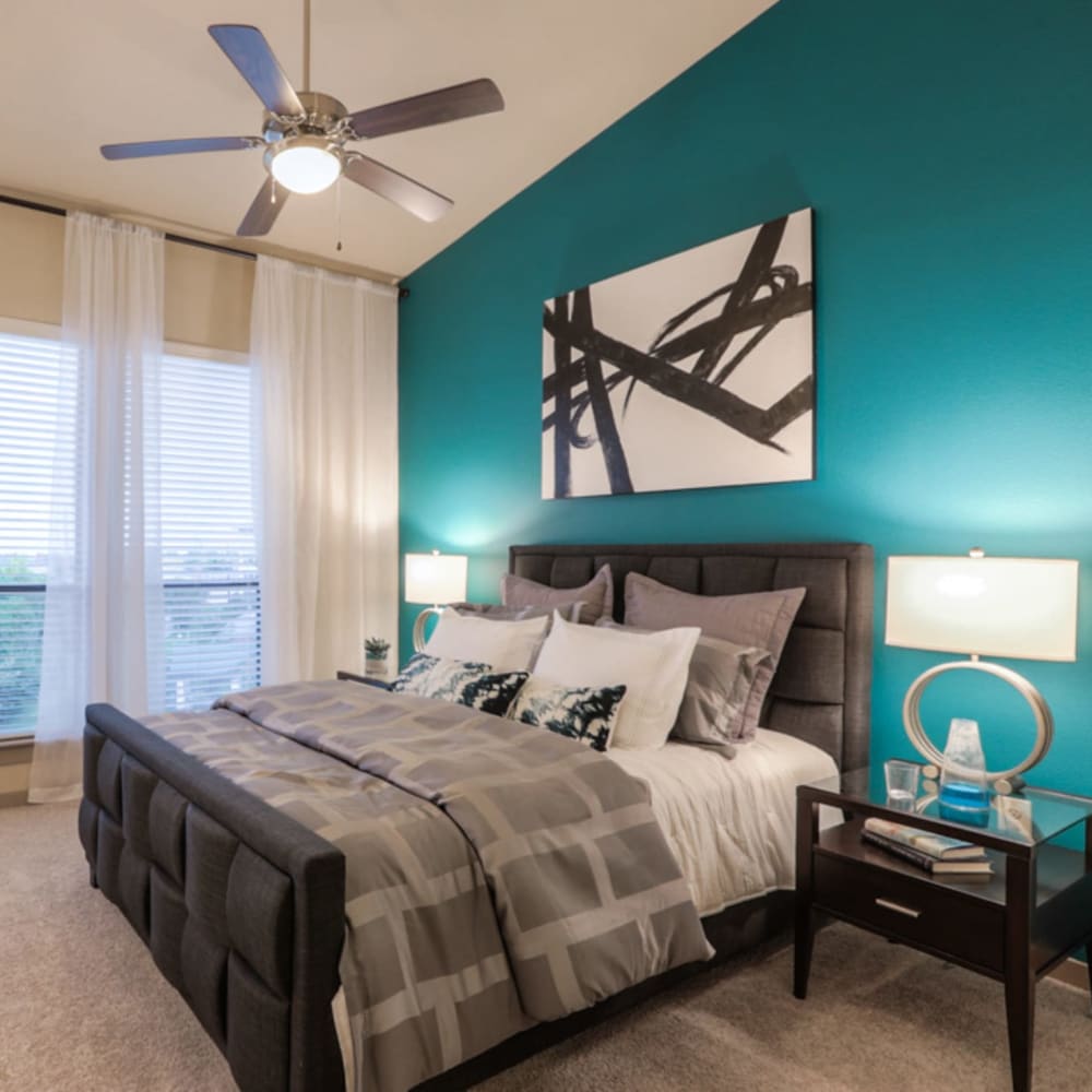Model bedroom with high ceilings and plush carpeting at Imperial Lofts in Sugar Land, Texas
