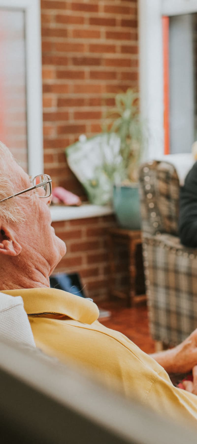 Group of residents talking in a common area at Bell Tower Residence Assisted Living in Merrill, Wisconsin