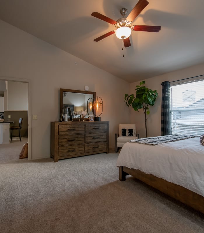 Chic bedroom with ceiling fan at Stonehorse Crossing Apartments in Oklahoma City, Oklahoma