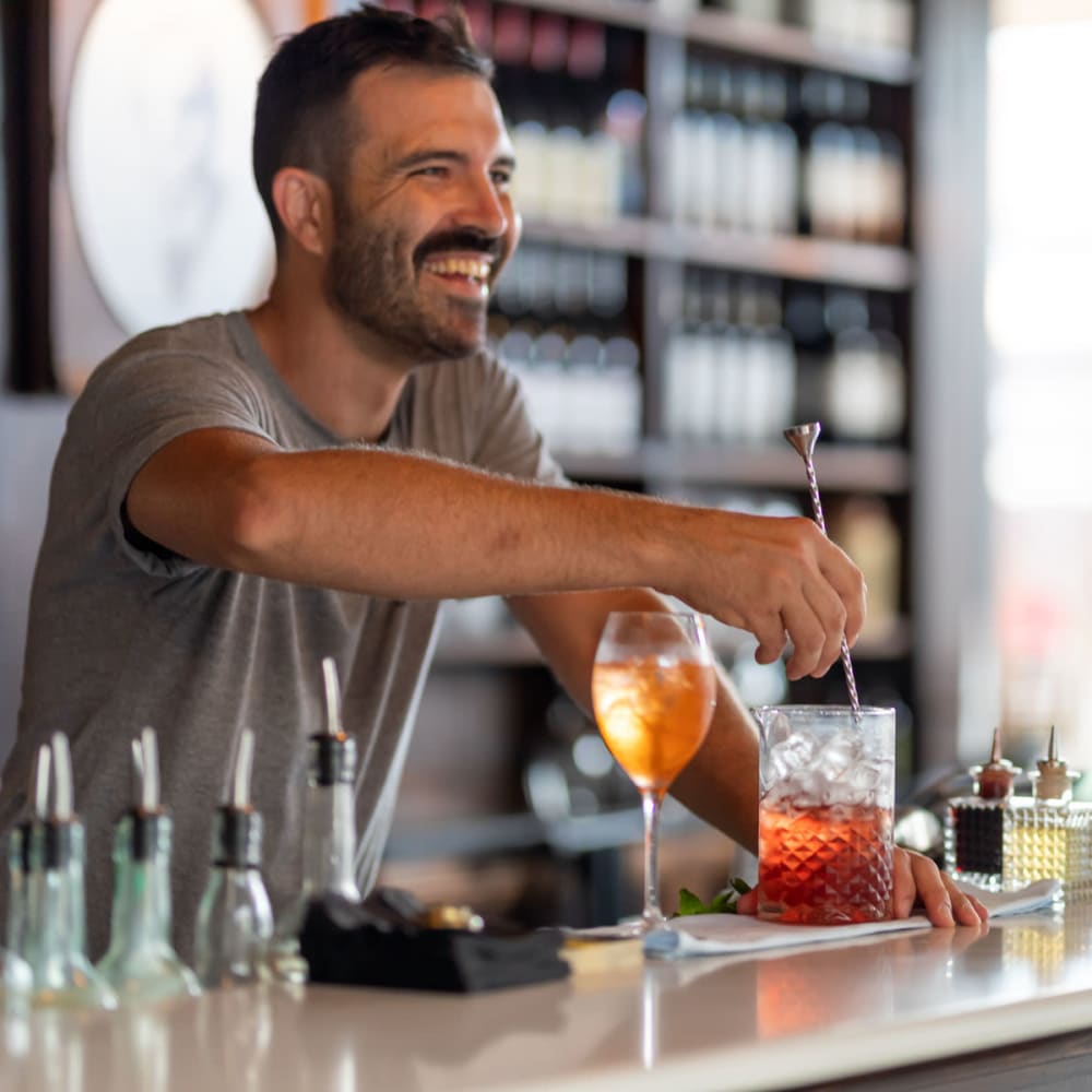 Bartender mixing up some cocktail magic at a restaurant near Oaks Trinity in Dallas, Texas