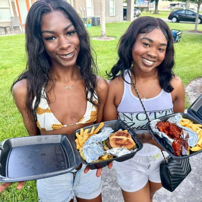 Friends enjoying a tasty food at Avalon Apartment Homes in Baton Rouge, Louisiana