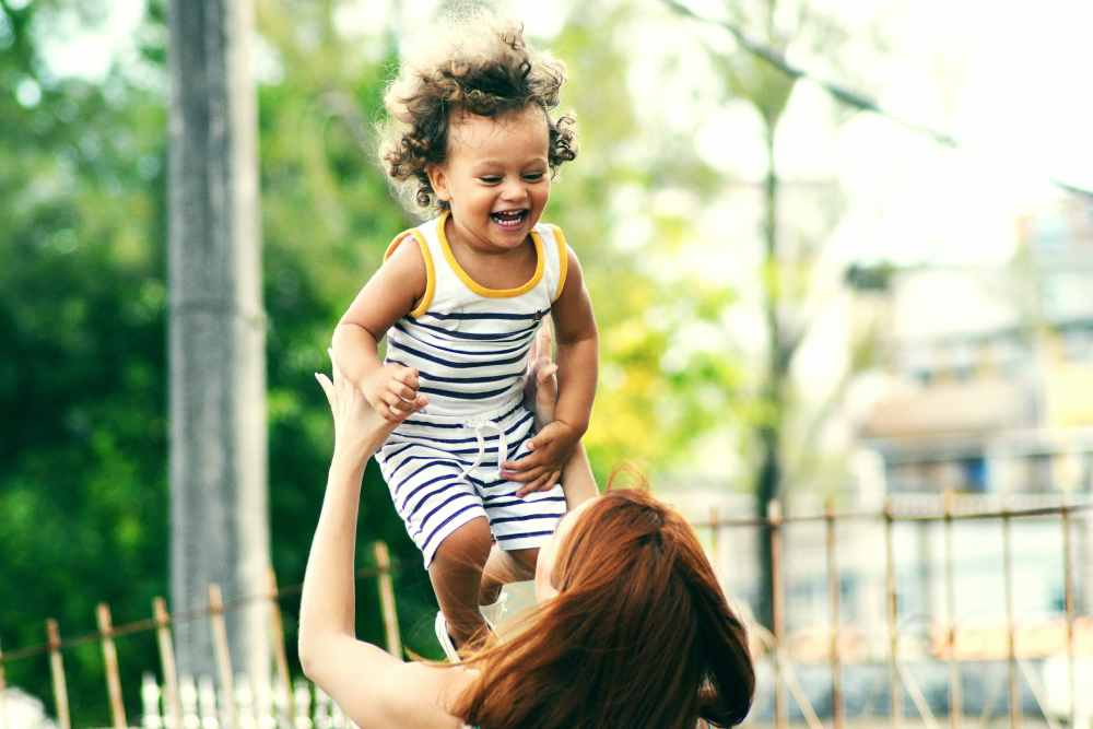 Resident and her baby playing at St. Albans Lofts in Raleigh, North Carolina,