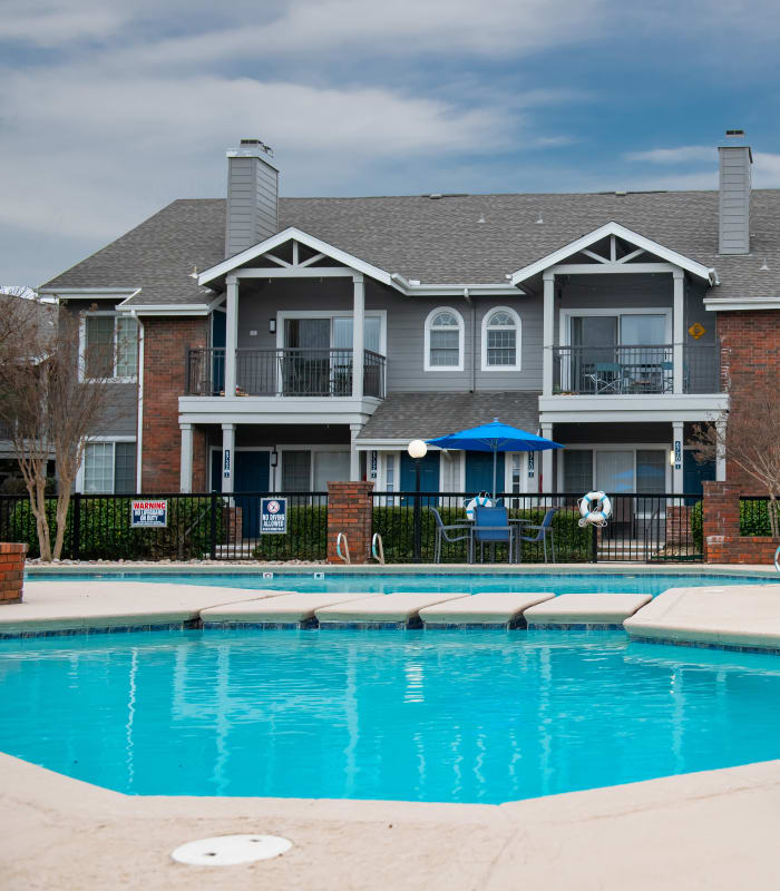 Spacious living room with large windows at The Courtyards in Tulsa, Oklahoma