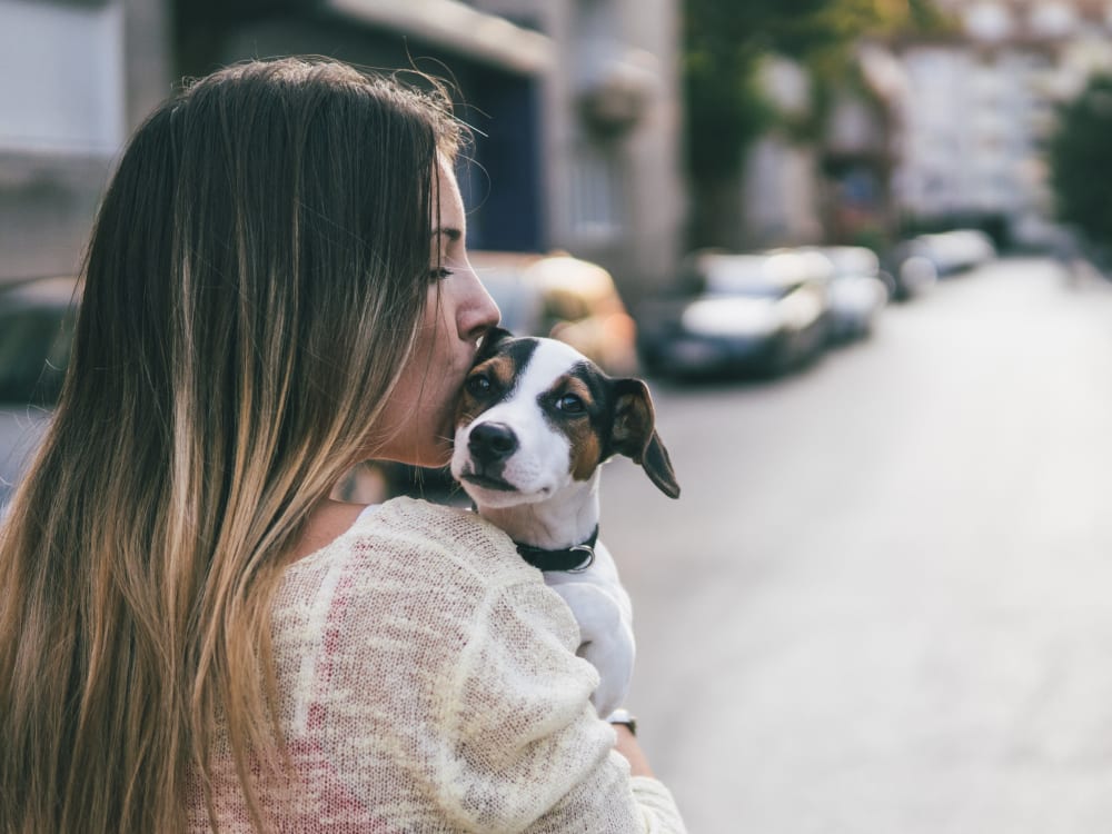 Resident holding her puppy up for a photo opportunity at Haven Apartment Homes in Kent, Washington