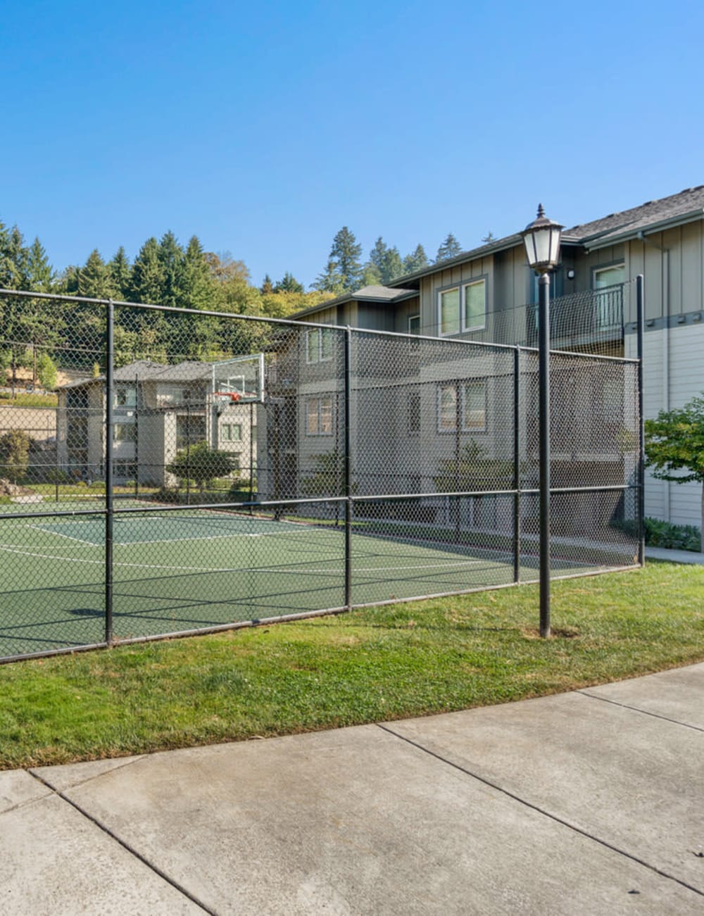 A black fenced basketball court at Columbia View in Vancouver, Washington