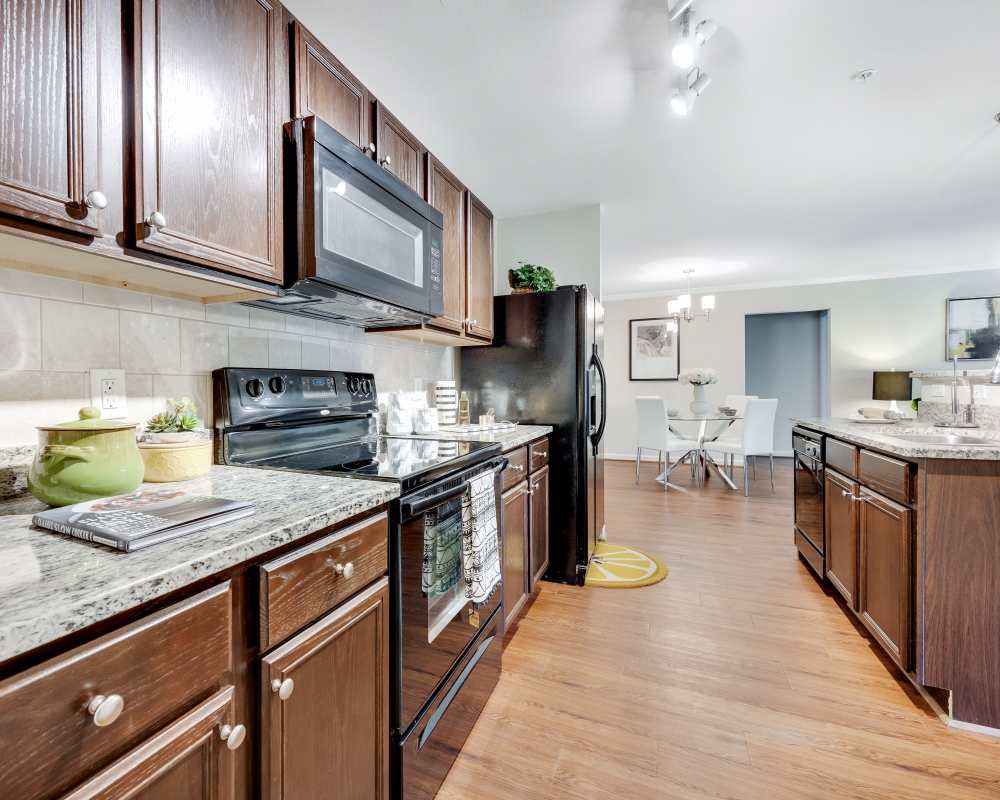 Modern Kitchen with black appliances at Enclave at Highland Ridge in Columbus, Georgia
