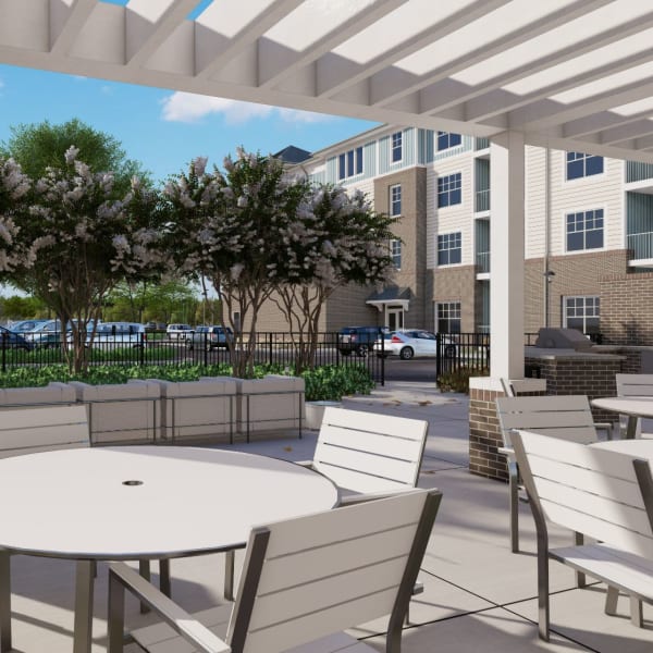 Outdoor gathering spot with tables and chairs at Acclaim at The Hill, Fredericksburg, Virginia