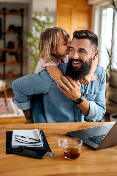 Happy resident holding his kid at Nolan Living in Leawood, Kansas