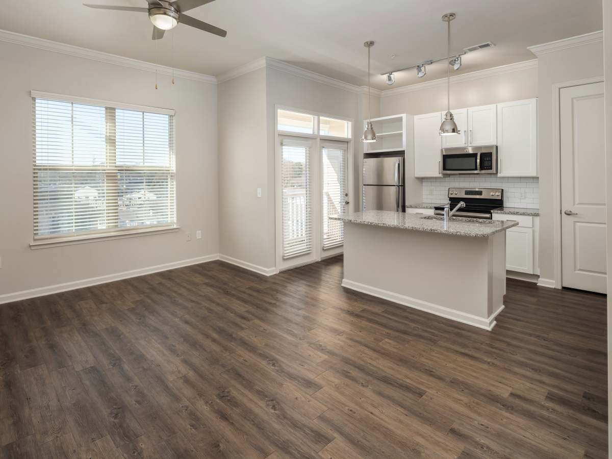 Gated light wood flooring with white cabinetry at Ardmore & Twenty Eighth in Atlanta, Georgia