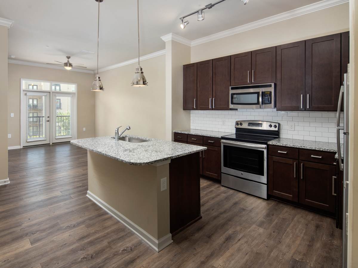 Luxury granite countertop with dark wood cabinets at Ardmore & Twenty Eighth in Atlanta, Georgia