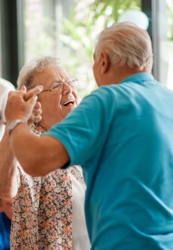 A resident couple dancing at Claiborne Senior Living. 