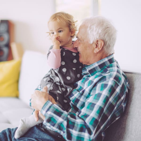 Man holding his grand daughter at Clearwater Living in Newport Beach, California