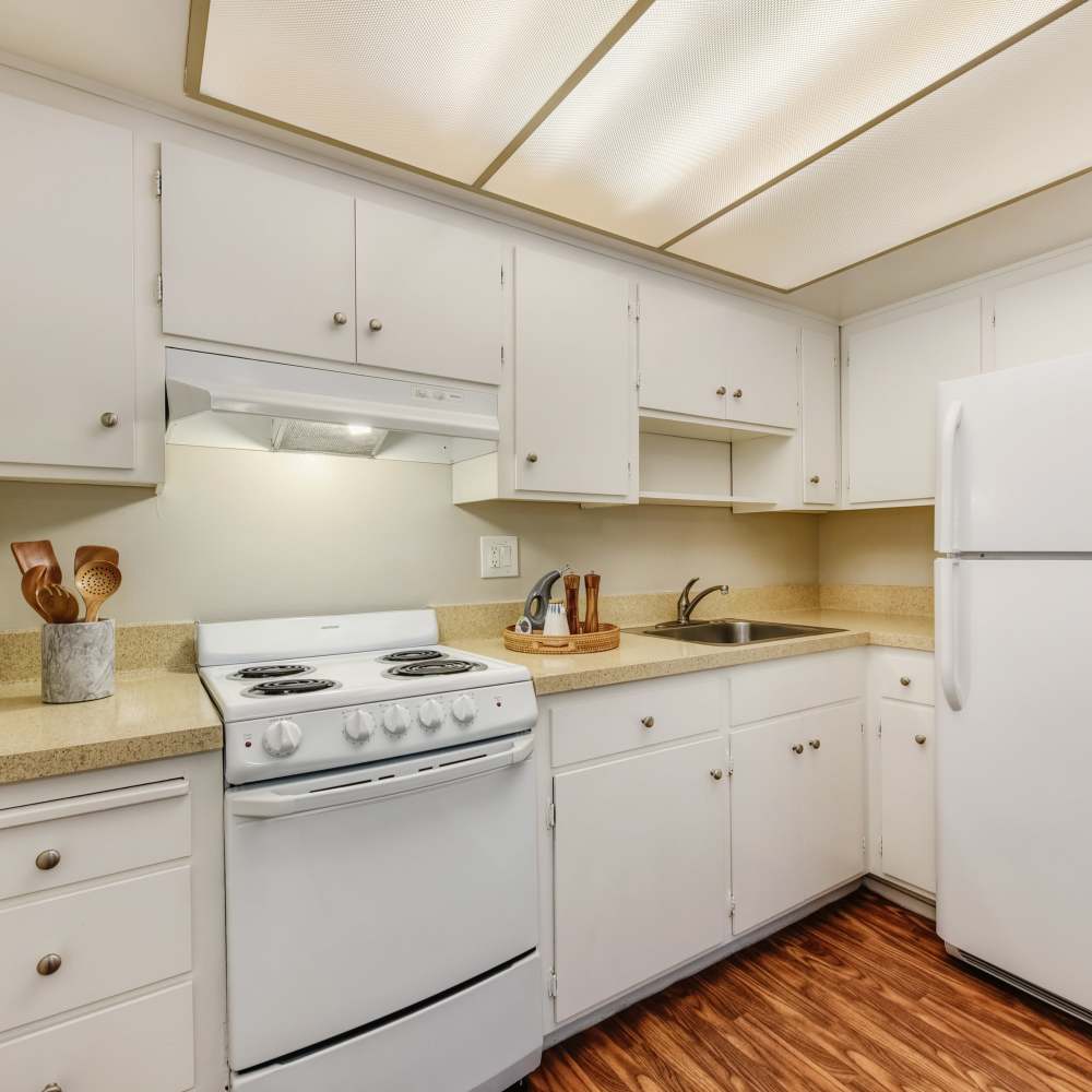 Kitchen with white appliances and cabinetry at Fayette Arms Apartments in Mountain View, California, 