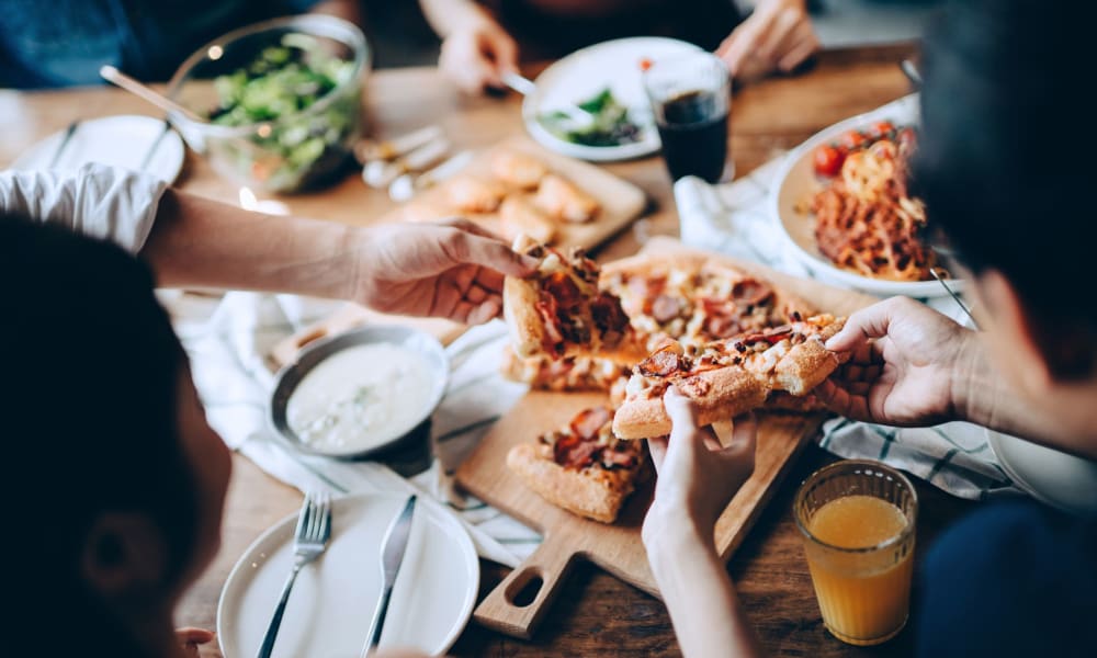 A group of residents eating pizza near Bellevue Mill in Hillsborough, North Carolina