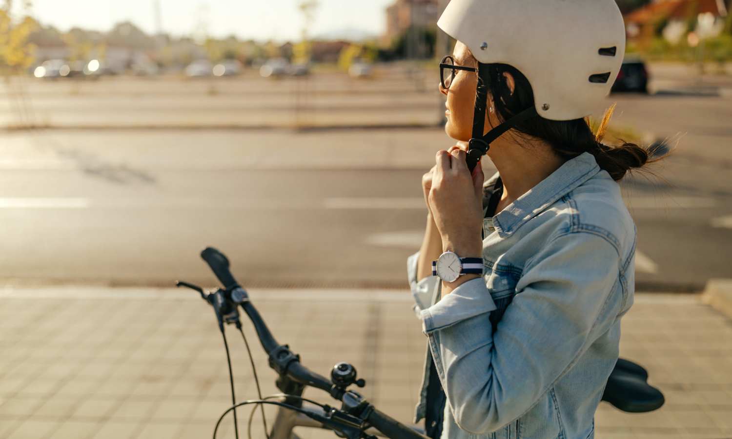 Person adjusting a bicycle helmet at Ardmore & Twenty Eighth in Atlanta, Georgia