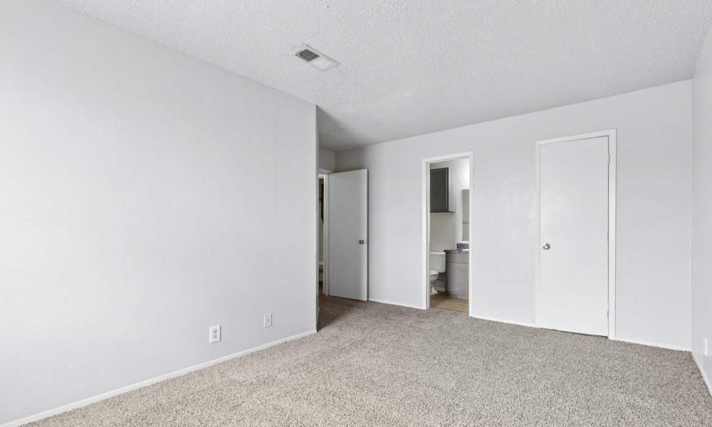 Cozy bedroom with carpet flooring at Arbors of Taylor in Taylor. TX