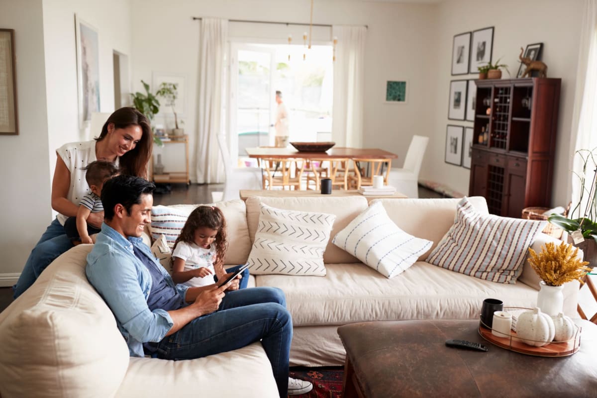 A family gathers around the sofa in their apartment at Kaitlin Court, Los Angeles, California