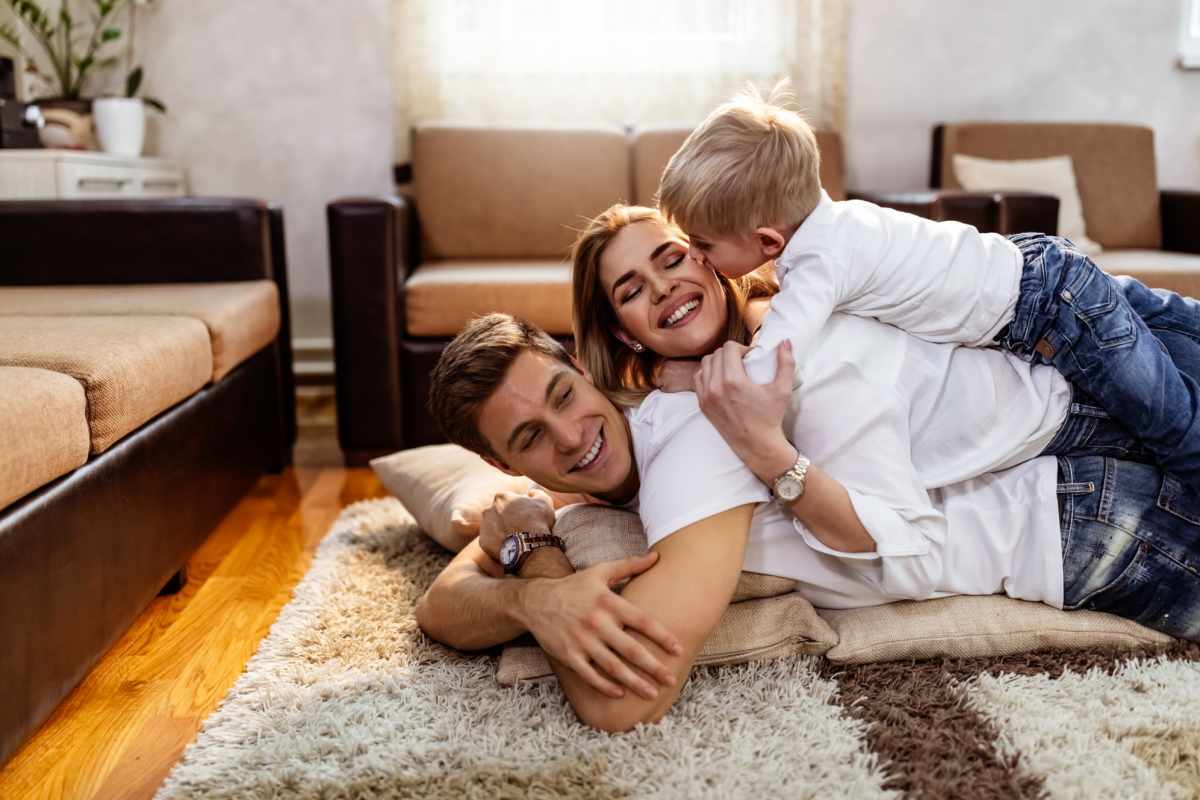Family playing together on living room floor at 311 Kenwood Parkway in Minneapolis, Minnesota