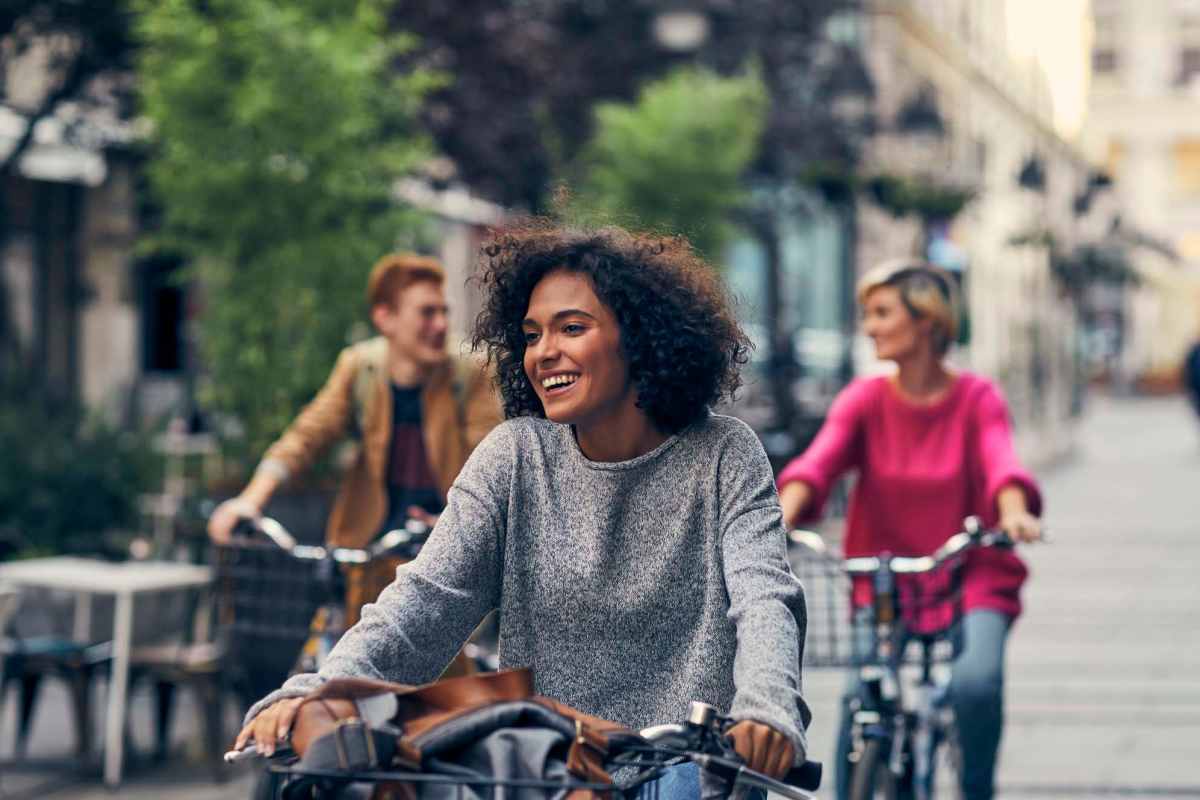 Charming urban scene featuring cyclists exploring picturesque streets lined with lush greenery at High Point Crossing Apartments in Augusta, Georgia 