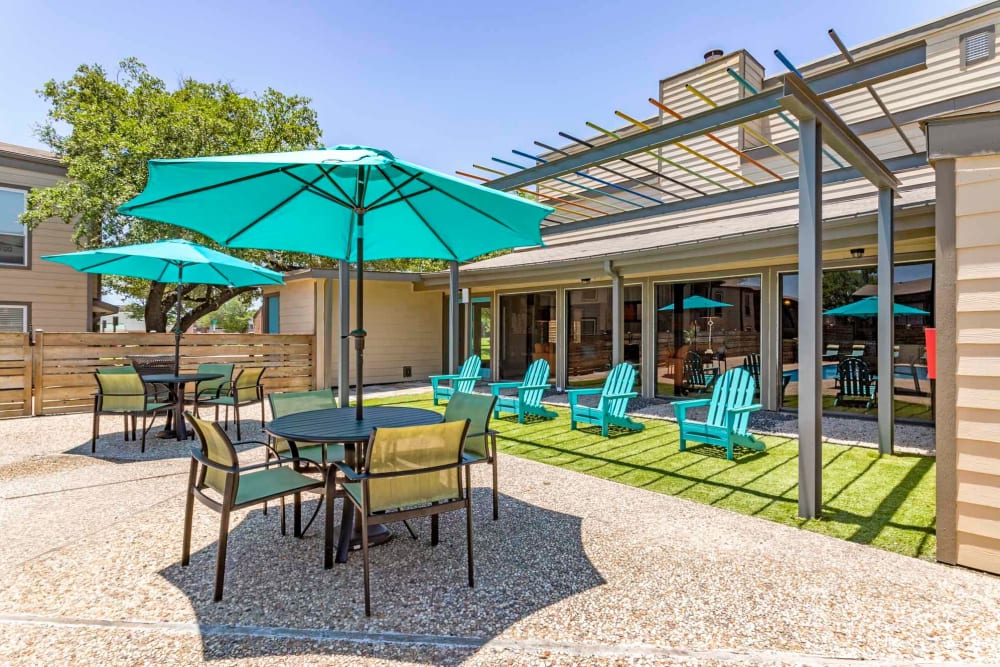 Resident outdoor lounge area by the pool at Sausalito Apartments in College Station, Texas