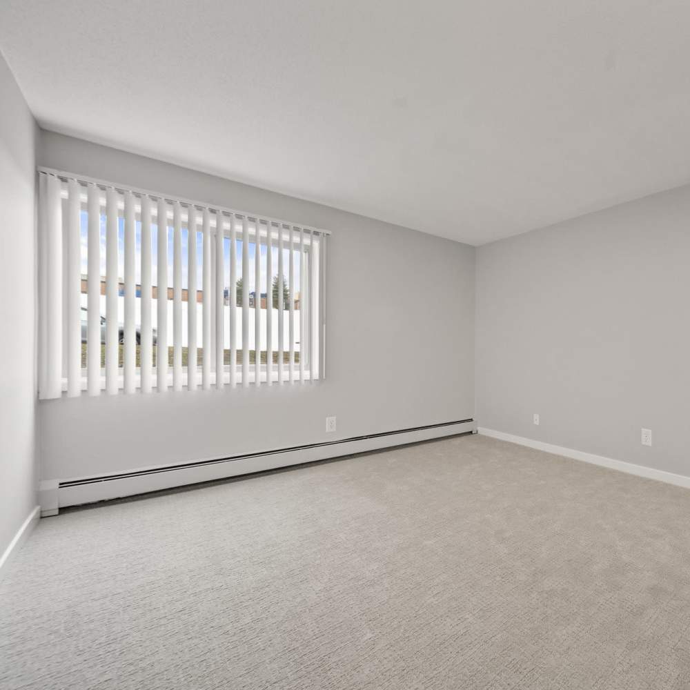 Well-lit bedroom with carpet flooring at Morada in Crystal, Minnesota