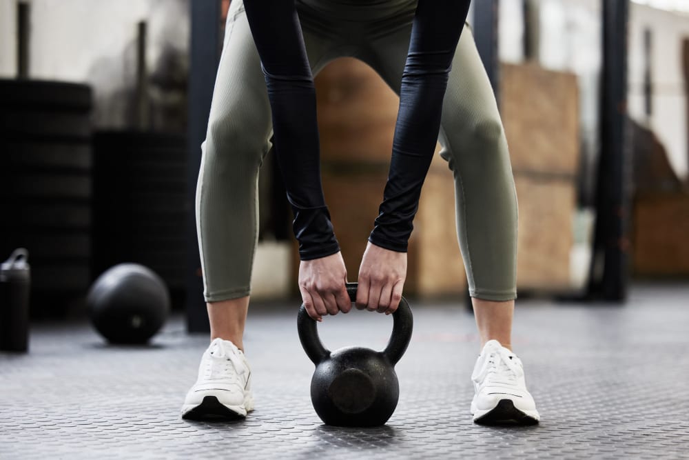 Resident lifting weights at the fitness facility at 1869 West in Pittsburgh, Pennsylvania