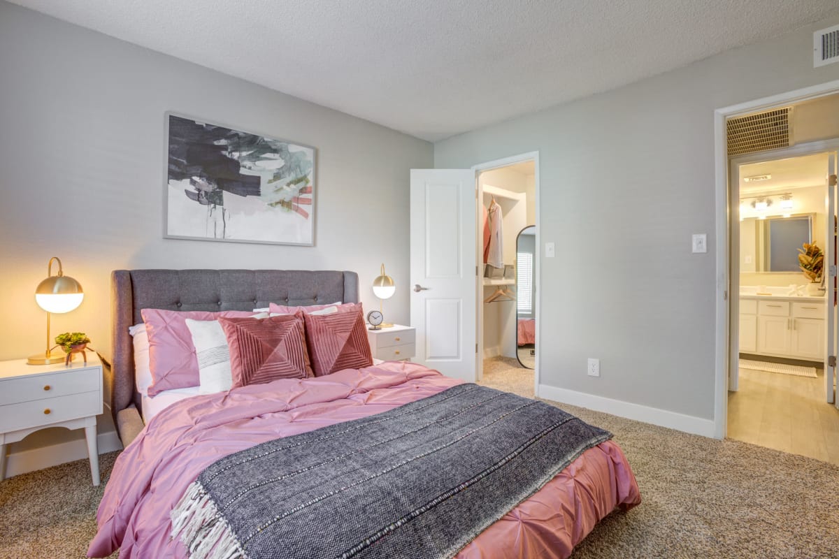 A cozy bedroom with a walk-in closet at Ardella on 67th in Glendale, Arizona