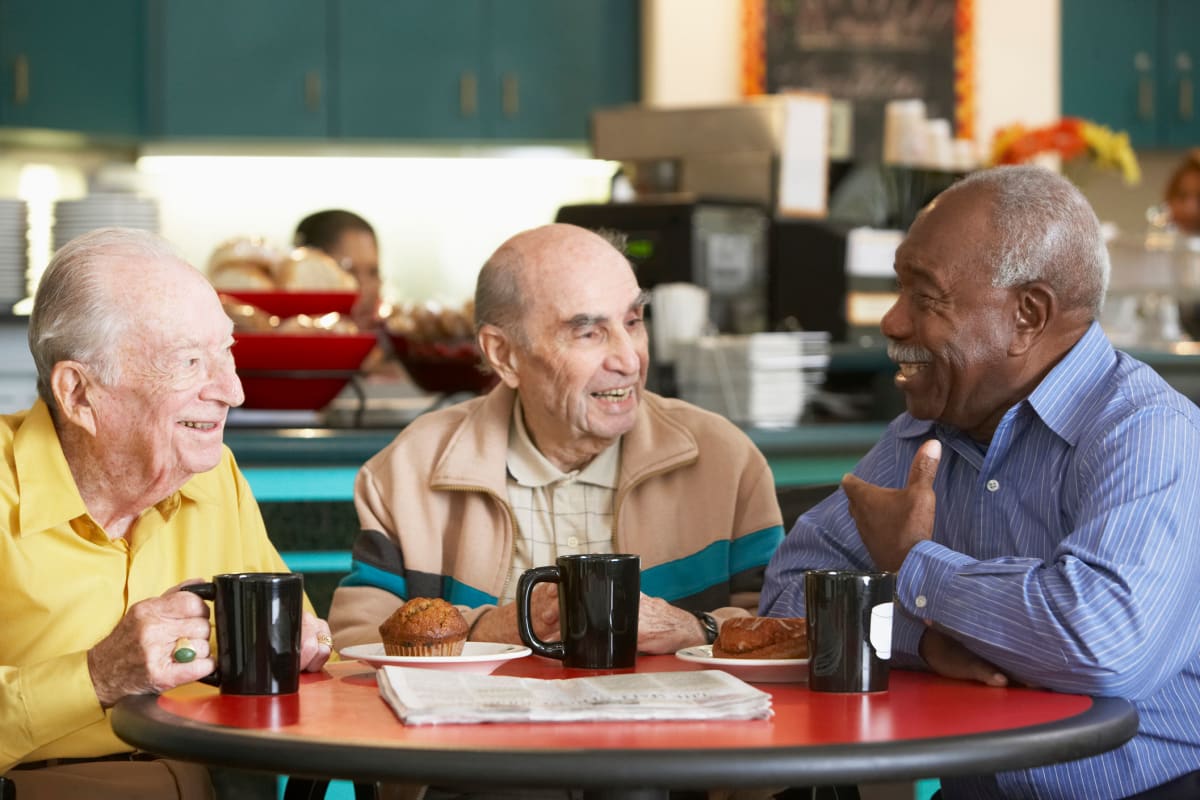 Resident friends drinking coffee together at The Claiborne at Hattiesburg Assisted Living in Hattiesburg, Mississippi. 