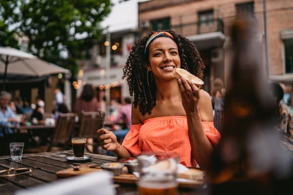 Resident eating on the patio of a favorite local spot near James River Pointe in Richmond, Virginia