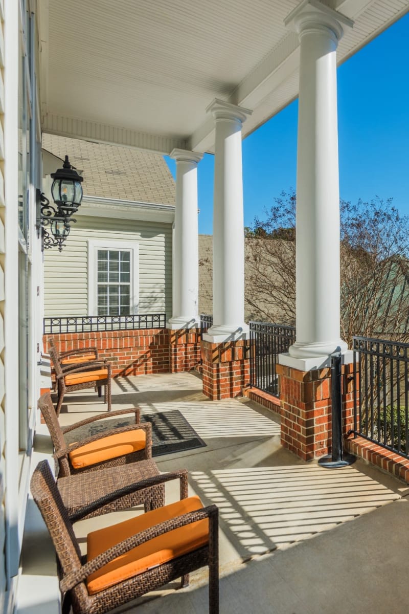 Covered patio overlooking the pool and grounds at The Preserve at Grande Oaks in Fayetteville, North Carolina