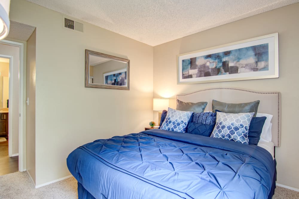 Master bedroom with hallway view to bathroom at Lakeview Village Apartments in Spring Valley, California