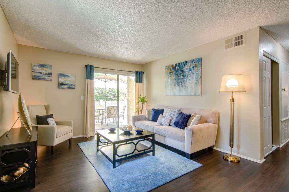 Living room with wood-style flooring at Lakeview Village Apartments in Spring Valley, California