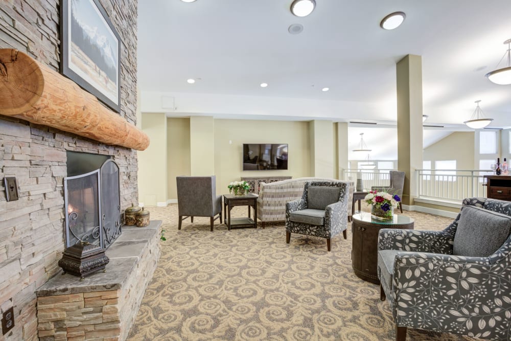 Chairs near fireplace at Timber Pointe Senior Living in Springfield, Oregon