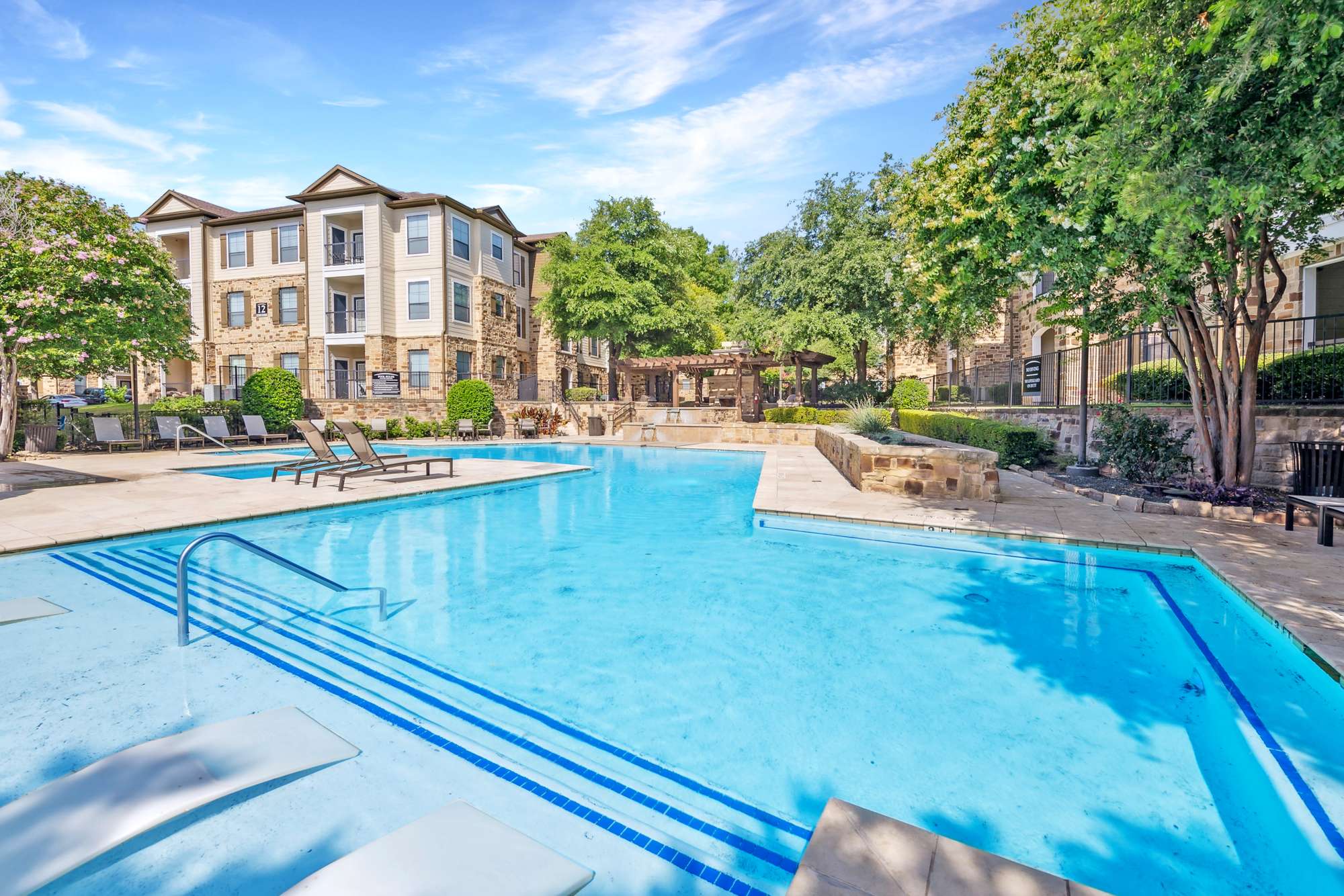 Pool and building exterior at Villas at Grand Avenue in Pflugerville, Texas