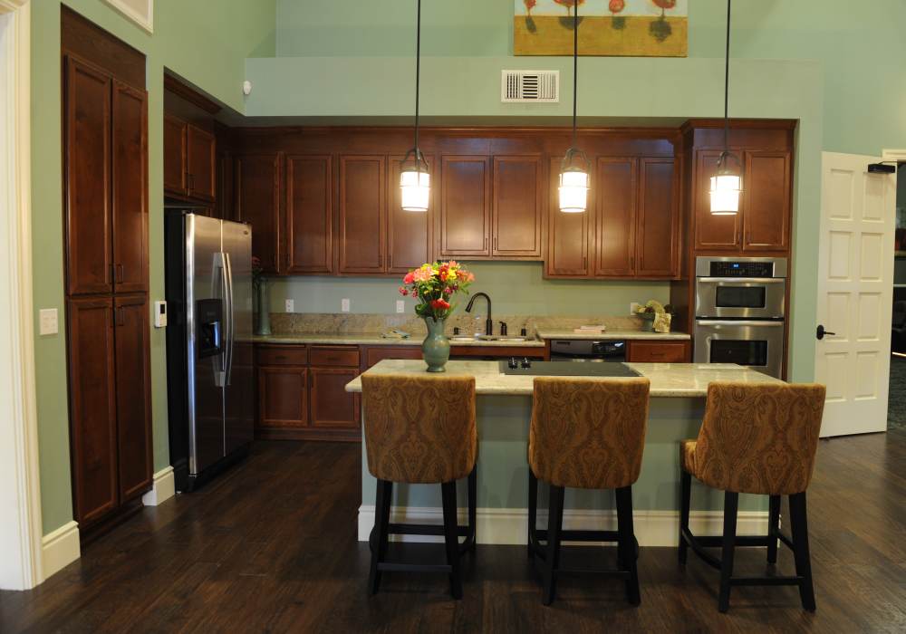 Modern kitchen with wooden cabinets at Cresta Bella in San Diego, California