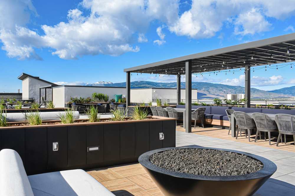 Outdoor dining area with grill and picnic table at Stone Village Apartments in Reno, Nevada
