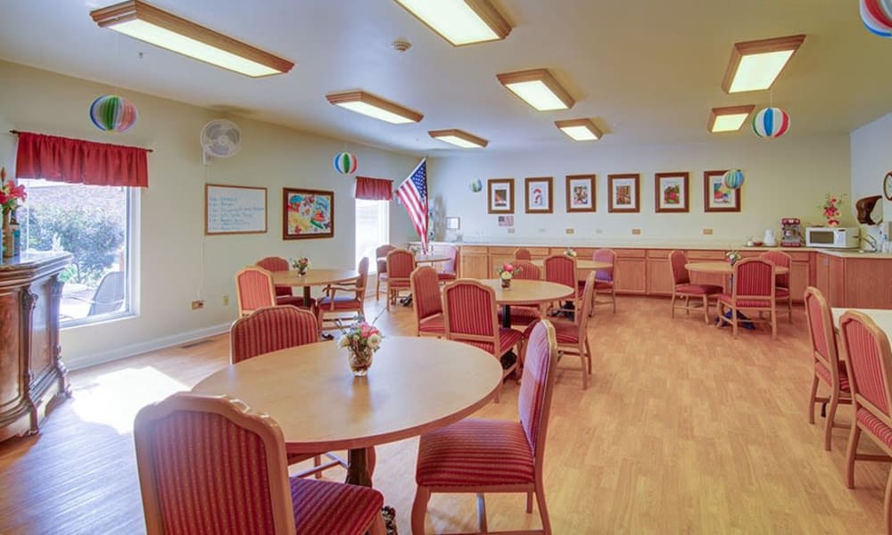 Activities room with round tables and spacious seating at Randall Residence of McHenry in McHenry, Illinois