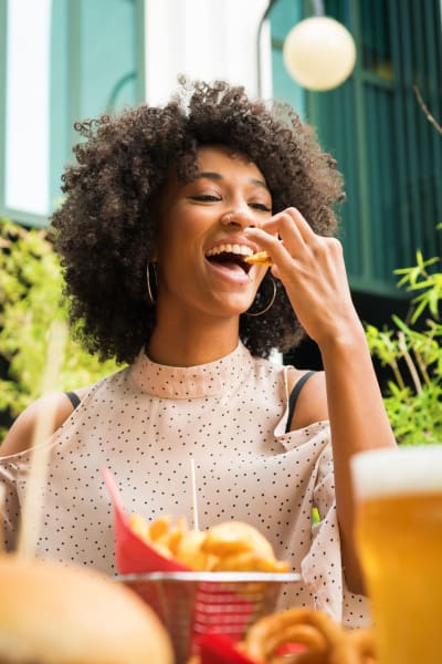 A resident enjoys a bite to eat and a cocktail near Kaitlin Court, Los Angeles, California
