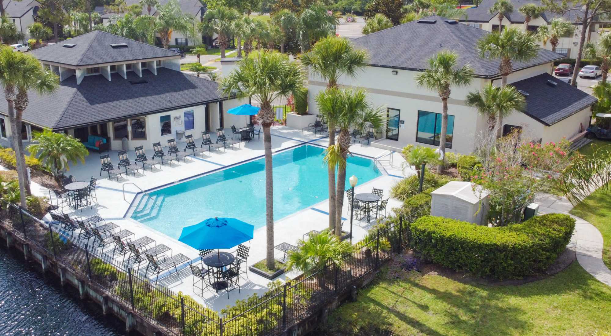 Aerial view of resort-style pool with lounge seating and clubhouse at Cypress Run in Orlando, Florida
