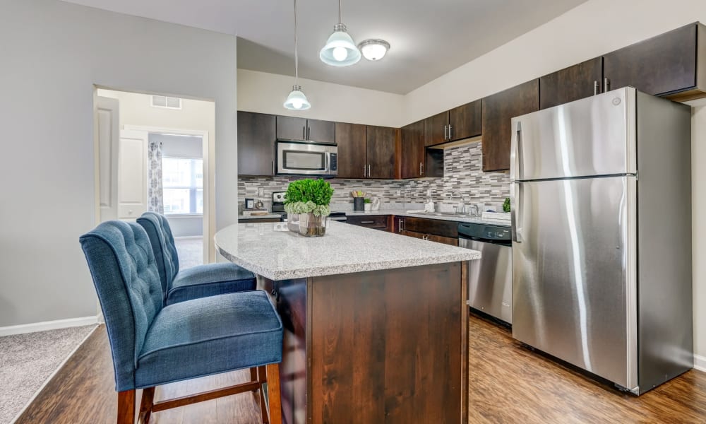 Contemporary kitchen with a breakfast bar and pendant lighting at Torrente Apartment Homes in Upper St Clair, Pennsylvania