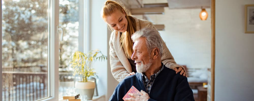 A woman talking to an elderly man at Ridgeline Management Company in Rockwall, Texas
