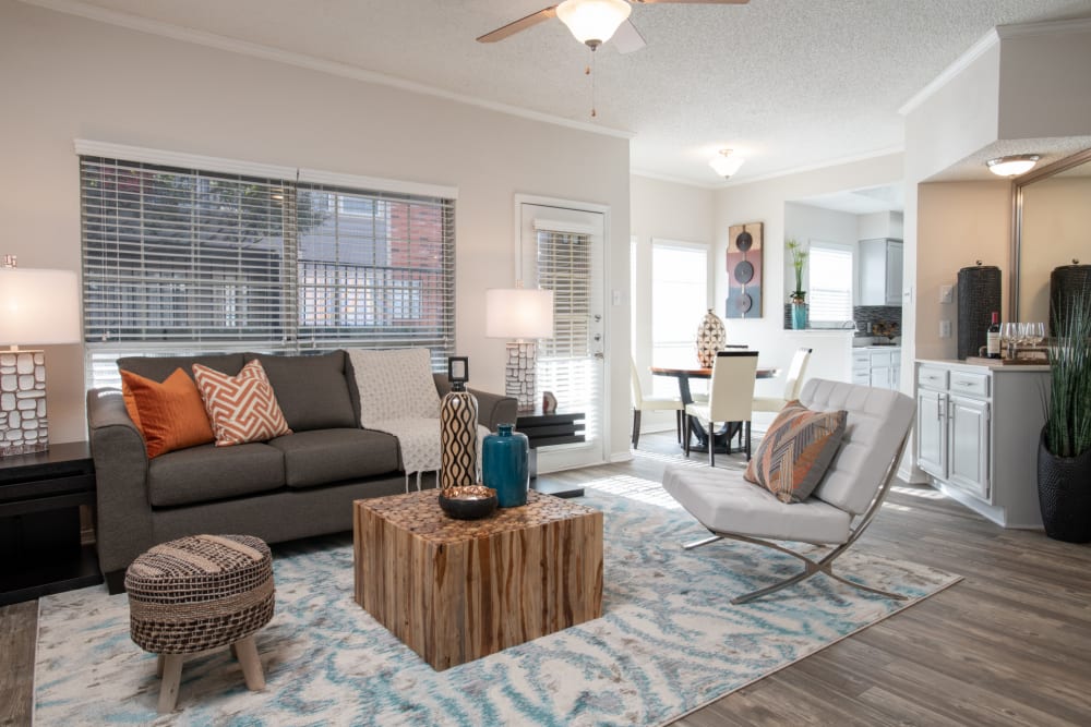 Well-designed living area of modern apartment with in-home fireplace at Copper Chase in Arlington, Texas