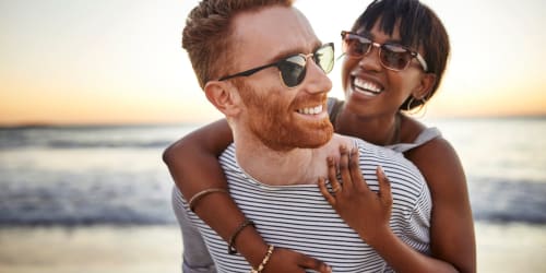 A smiling couple at the beach near Serramonte Ridge Apartment Homes in Daly City, California