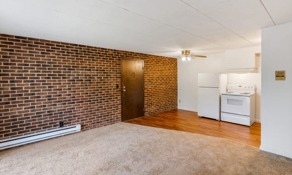 Spacious living room with brick accent wall at Brixworth Apartments in Cincinnati, Ohio