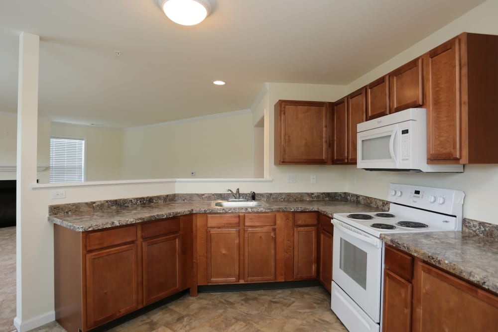 Kitchen with white appliances at The Ridge in Troy, New York