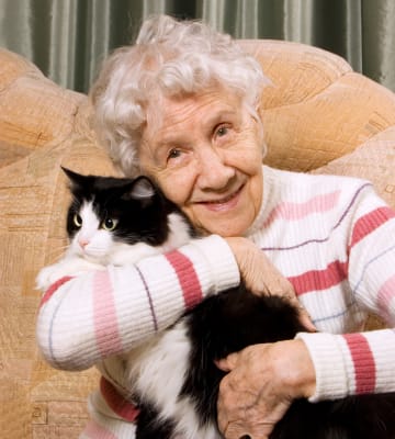 Resident hugging her cat at Absaroka Senior Living in Cody, Wyoming