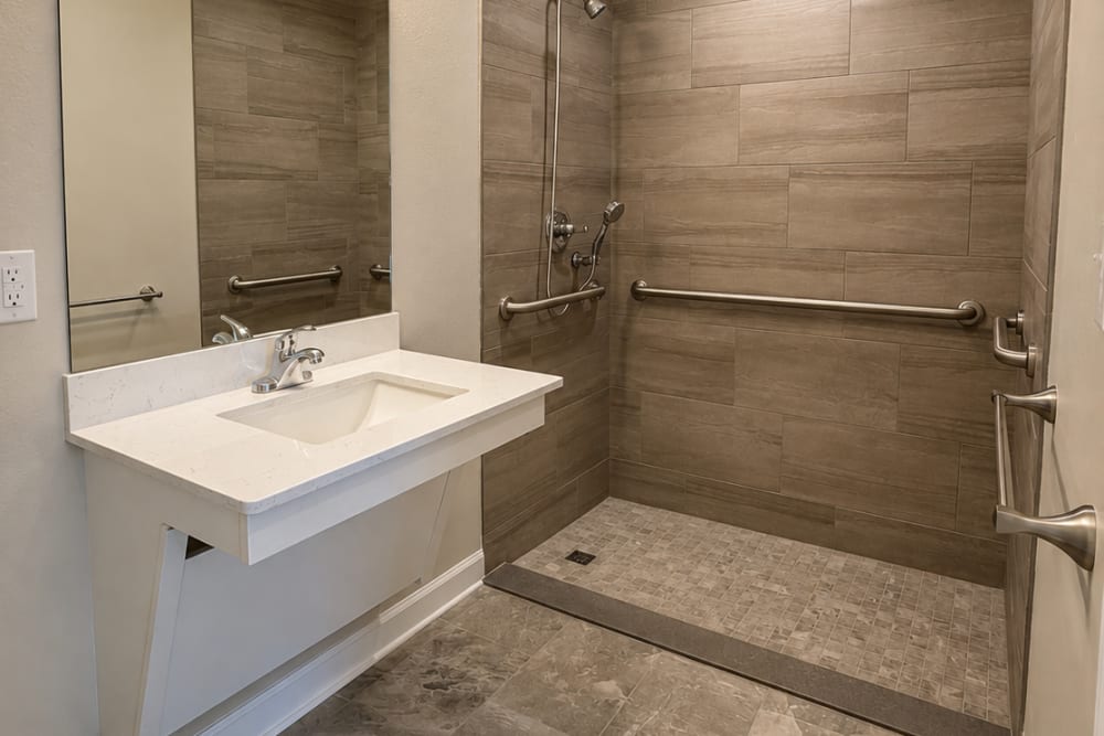 Bathroom with walk-in shower at Village Springs Apartments in Defuniak Springs, Florida