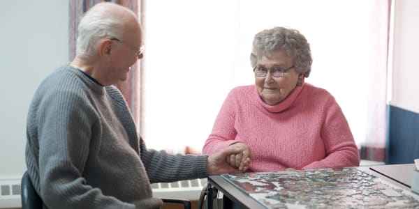 Residents having fun putting a puzzle together at Ingleside Communities in Mount Horeb, Wisconsin