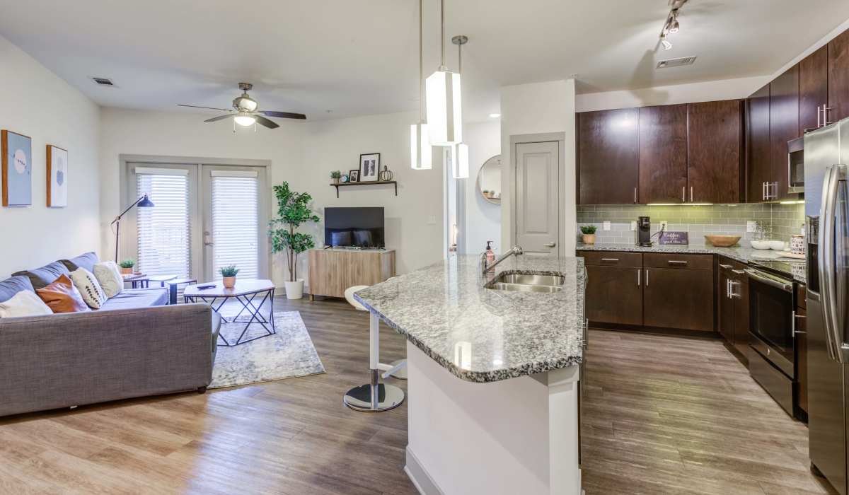 Living room with connecting kitchen at The Carillon in Nashville, Tennessee